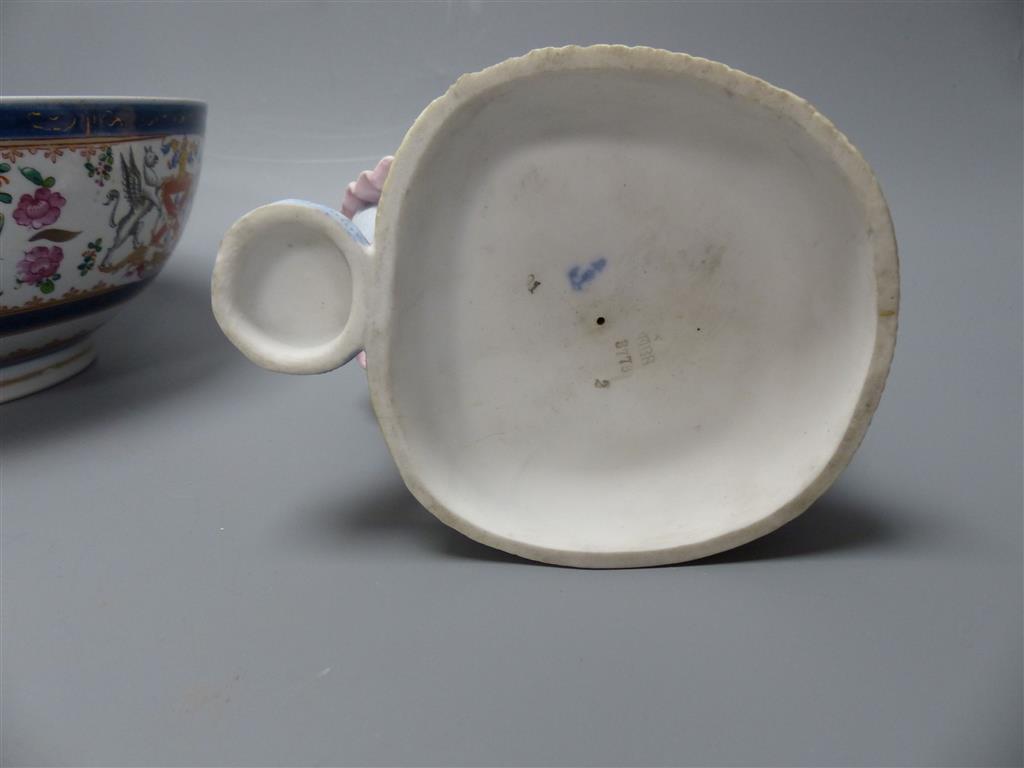 A French coloured biscuit porcelain figure of a seated girl and a Samson armorial bowl, c.1900, diameter 23cm